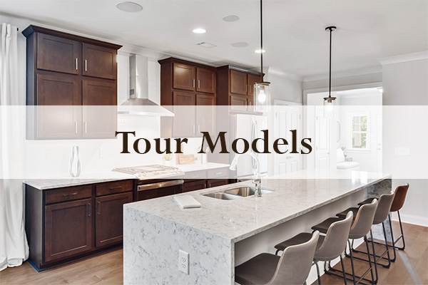 Tour Models with large waterfall kitchen island